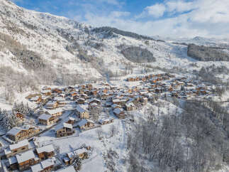 Discover this charming alpine village nestled amidst snow-capped mountains, offering a picturesque winter wonderland setting.