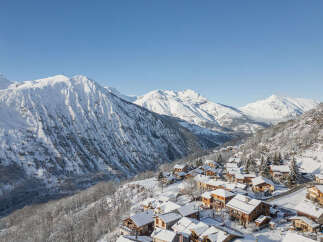 Discover this charming alpine village nestled amidst snow-capped mountains, offering a picturesque winter wonderland setting.