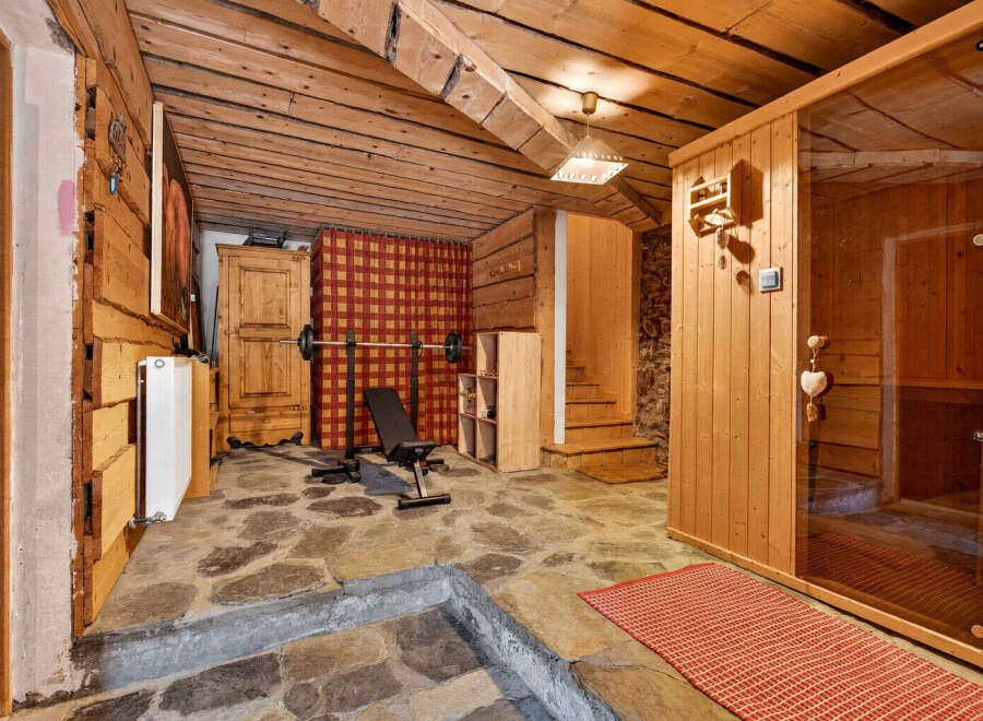 Experience ultimate relaxation and fitness in this unique home gym and sauna space.