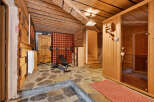 Experience ultimate relaxation and fitness in this unique home gym and sauna space.