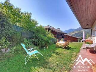 Enjoy the stunning mountain views from this charming property's garden, complete with a picnic table and chairs for al fresco dining.