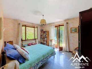 This charming bedroom features a comfortable bed adorned with blue and white pillows, perfect for a restful night's sleep.