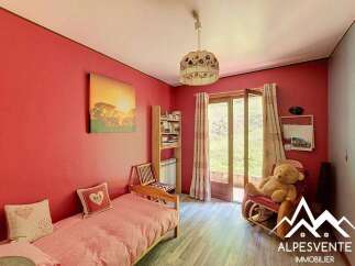 This charming room features a cozy single bed with pink polka dot bedding, perfect for a child's bedroom or guest room.