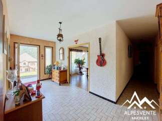 Step into this charming entryway featuring a decorative red guitar mounted on a textured wall, adding a unique artistic flair.