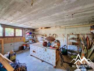 Discover this versatile space, perfect for a workshop or storage area, featuring a large vintage dresser with numerous drawers for organization.