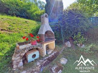 Enjoy outdoor living with this charming stone barbecue area, perfect for summer gatherings.