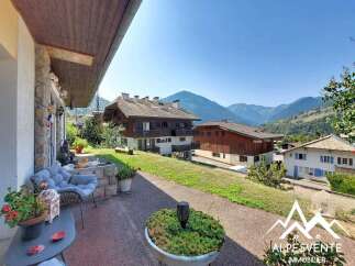 Enjoy breathtaking mountain views from this charming property, featuring a cozy outdoor seating area perfect for relaxing.