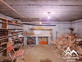 Discover this spacious basement area, perfect for storage or a workshop, featuring ample shelving and a sturdy workbench.