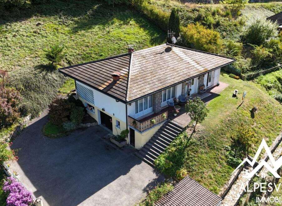 Discover this charming property nestled on a verdant hillside, offering a picturesque setting with lush greenery and stunning natural views.