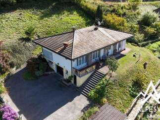 Discover this charming property nestled on a verdant hillside, offering a picturesque setting with lush greenery and stunning natural views.