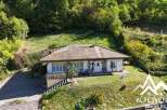 Nestled amidst lush greenery, this charming property offers a serene mountain retreat.