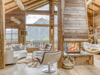 Experience luxurious mountain living in this stunning chalet featuring a grand fireplace and breathtaking panoramic views.