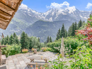 Experience breathtaking mountain views from this charming chalet's patio, perfect for enjoying the alpine scenery.