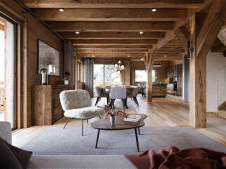 Experience rustic luxury in this stunning mountain lodge-inspired living space, featuring exposed wooden beams and a cozy, plush armchair.
