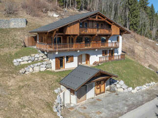 Nestled on a picturesque hillside, this charming wooden chalet offers breathtaking mountain views and a serene escape.