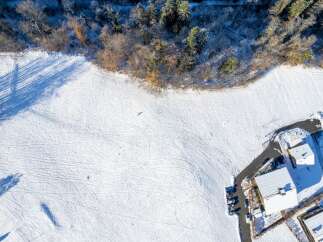 Experience the serene beauty of winter with this stunning aerial view.