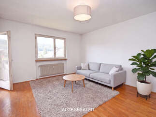 Step into this inviting living room, featuring a plush grey sofa and a round wooden coffee table perfect for gatherings.
