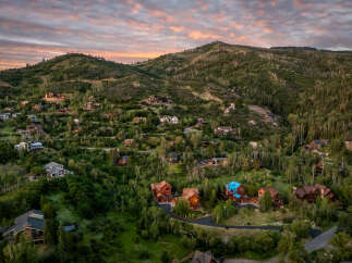 Experience luxury mountain living in this stunning estate nestled amidst a serene forest landscape.