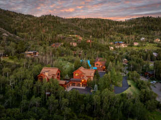 Nestled amidst a lush forest, this stunning mountain home offers breathtaking views and luxurious living.