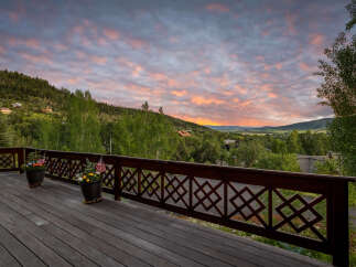 Experience breathtaking mountain views from this stunning deck, perfect for enjoying serene sunrises and vibrant sunsets.