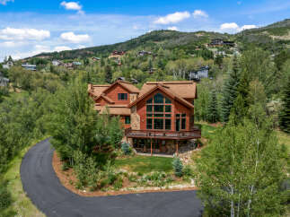 Nestled amidst lush greenery and rolling hills, this stunning mountain home offers breathtaking panoramic views.