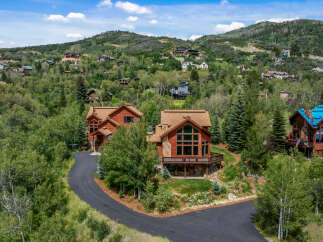 Nestled amidst lush greenery and rolling hills, this stunning mountain home offers breathtaking views and luxurious living.