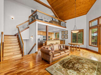 Experience luxury living in this stunning home featuring a grand staircase and an open-concept living area.
