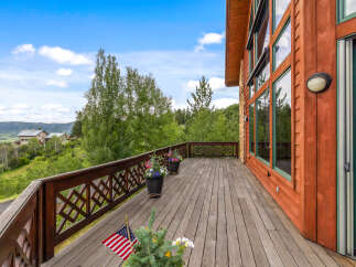Experience breathtaking mountain views from this expansive wooden deck, perfect for outdoor entertaining or quiet relaxation.