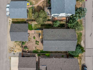 Discover this charming property from an aerial perspective, showcasing a well-maintained roof and a spacious backyard perfect for outdoor activities.
