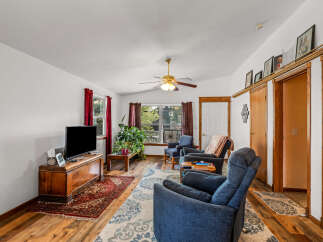 Step into this inviting living room, featuring a cozy seating area perfect for relaxation and entertainment.