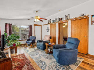 Step into this inviting living room, featuring comfortable blue upholstered chairs perfect for relaxation.