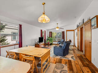 Discover comfortable living in this inviting space, featuring a versatile dining area adjacent to a cozy living room.