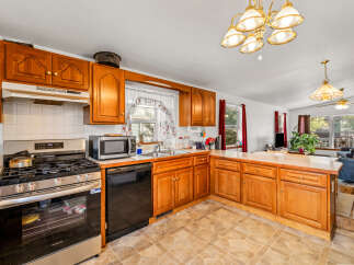 Discover this charming kitchen featuring warm wooden cabinetry and a functional layout perfect for everyday living.