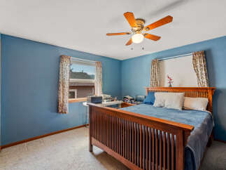 This cozy bedroom features a warm wooden bed frame and a calming blue paint scheme.