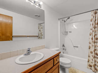 This bathroom features a spacious vanity with a sink and ample counter space, perfect for your morning routine.
