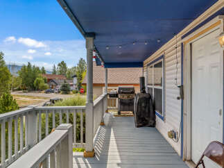 Enjoy outdoor living on this charming covered porch, perfect for relaxing or entertaining.