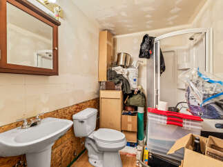 This bathroom is a work in progress, offering a blank canvas for your personal design touches.