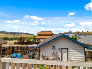 Discover this charming property featuring a detached garage with a bright white exterior and a striking blue trim, perfect for storage or a workshop.