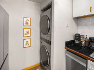 Discover modern convenience with this stacked LG washer and dryer, perfect for maximizing space in your home.