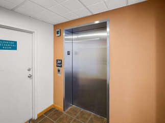 This image showcases an elevator lobby with a clean, modern aesthetic.