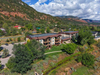 Nestled against a backdrop of stunning red rock mountains and lush greenery, this property offers a serene living experience.