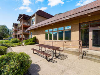 Enjoy outdoor dining and relaxation on this spacious patio, complete with a picnic table and benches.