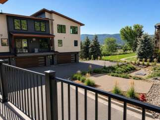Discover modern living in this stunning townhouse featuring a sleek exterior with dark siding and beige stucco.
