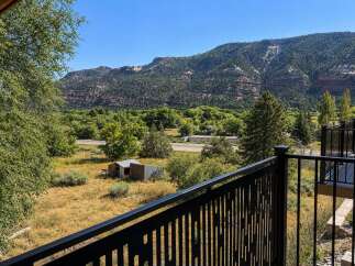 Experience breathtaking mountain views from this property, offering a serene escape surrounded by lush greenery and rugged terrain.