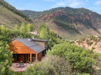 Nestled amidst lush greenery and towering mountains, this stunning property offers a serene escape.