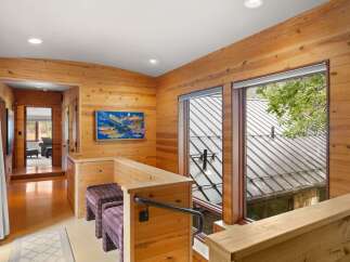 This charming interior features warm wood paneling throughout, creating a cozy and rustic atmosphere.