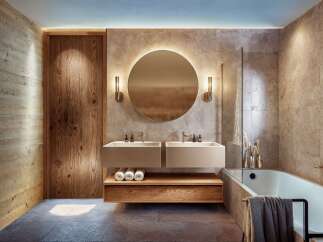 Experience luxury in this modern bathroom featuring a floating double vanity with sleek undermount sinks and a warm wood accent shelf.