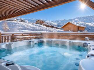 Experience ultimate relaxation in this luxurious mountain retreat, featuring a steaming hot tub with breathtaking views of snow-capped peaks.