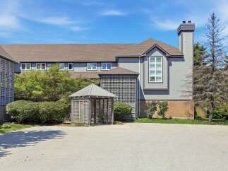 Discover this charming property featuring a unique lattice-covered gazebo, perfect for outdoor relaxation.