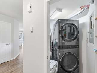 Discover modern convenience with this stacked LG ThinQ washer and dryer set, perfect for optimizing space in your laundry area.